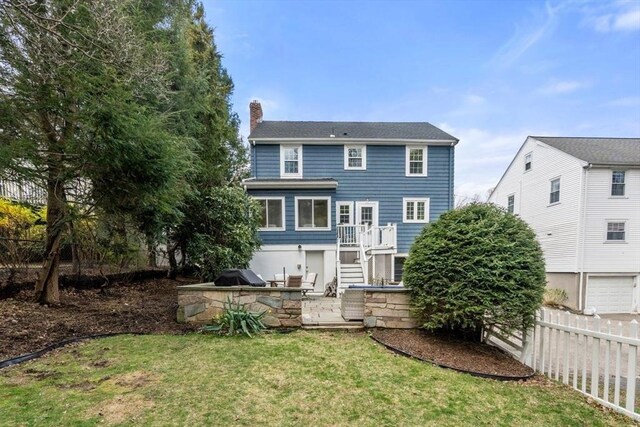 rear view of house featuring a chimney and an outdoor kitchen