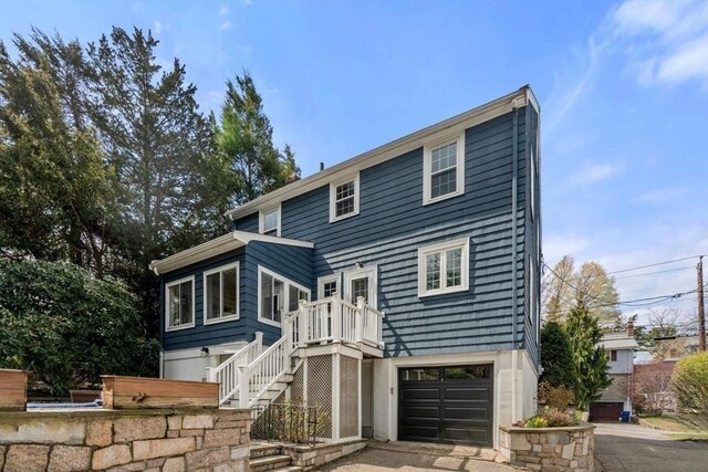 view of front of house featuring an attached garage and stairway
