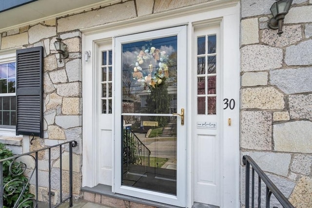 entrance to property featuring stone siding