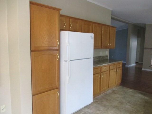 kitchen with white fridge and light wood-type flooring