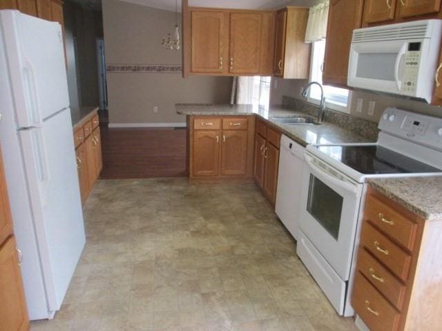 kitchen featuring white appliances and sink