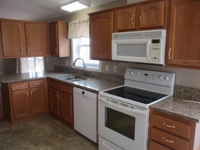 kitchen featuring white appliances and sink