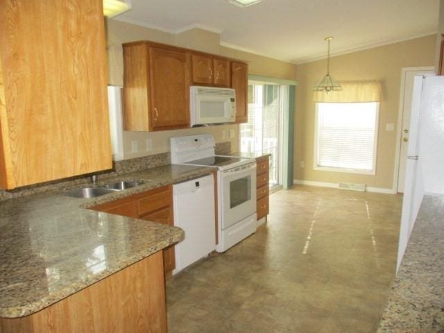 kitchen with stone counters, sink, crown molding, decorative light fixtures, and white appliances