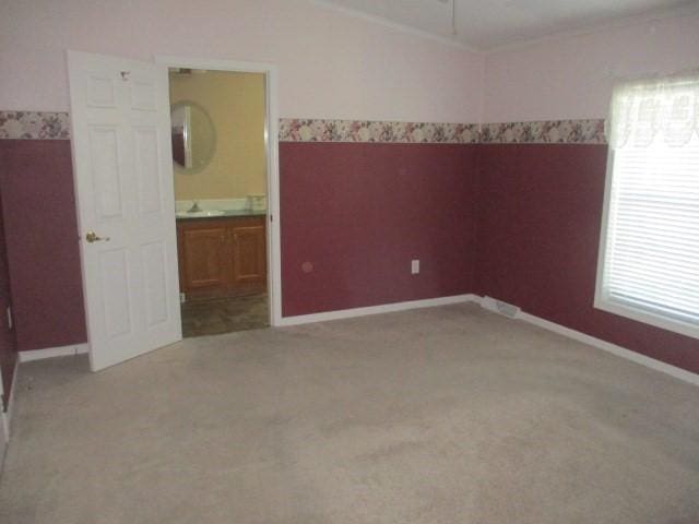 unfurnished room featuring plenty of natural light and light colored carpet