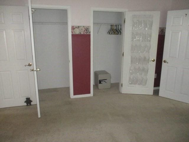 unfurnished bedroom featuring light colored carpet