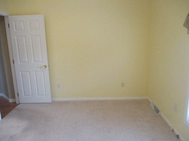 spare room with light carpet