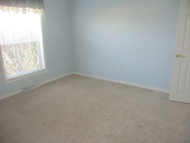 empty room with carpet flooring