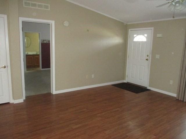 foyer entrance with ceiling fan, dark hardwood / wood-style flooring, and ornamental molding