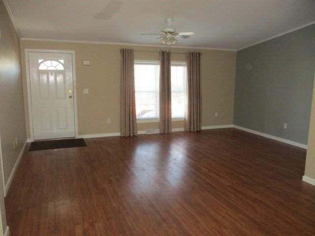 entryway with crown molding, ceiling fan, and dark wood-type flooring