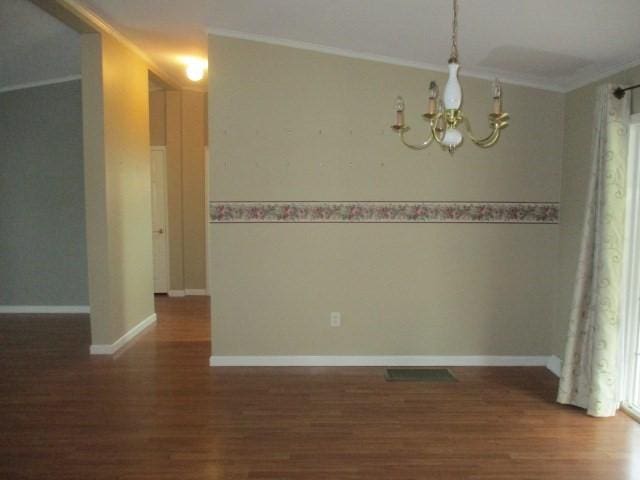 unfurnished room with dark hardwood / wood-style floors and ornamental molding