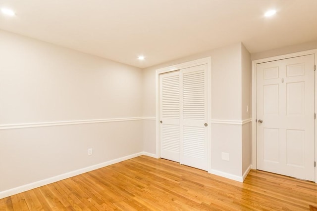 unfurnished bedroom featuring light hardwood / wood-style flooring and a closet