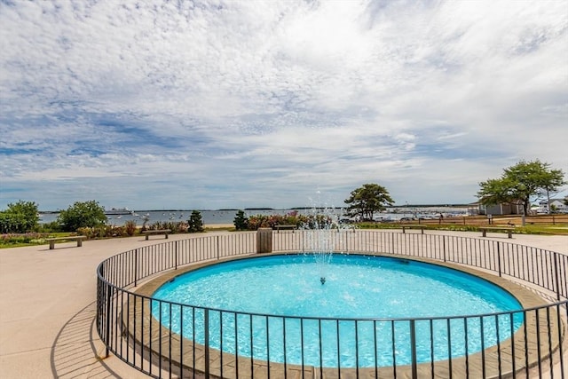 view of swimming pool with a water view