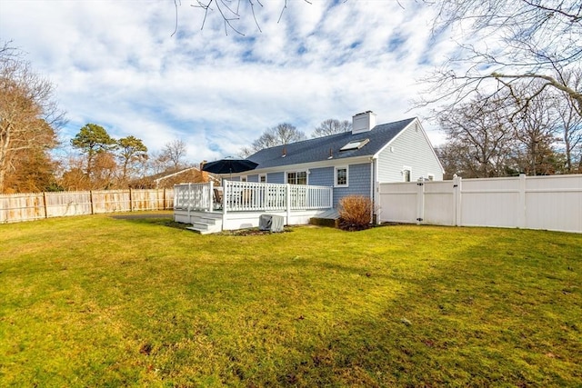 back of house with a yard and a deck