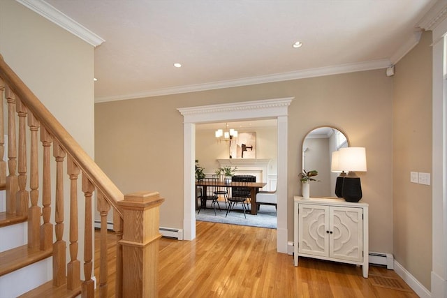 hall with stairway, crown molding, light wood finished floors, and baseboard heating