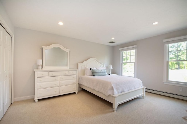 bedroom with recessed lighting, a baseboard radiator, multiple windows, and light colored carpet