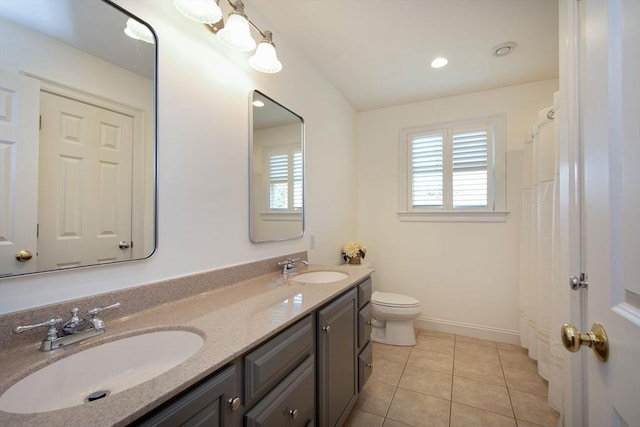 bathroom featuring plenty of natural light, tile patterned flooring, and a sink