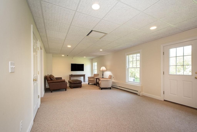 sitting room featuring a drop ceiling, recessed lighting, a baseboard heating unit, carpet flooring, and baseboards