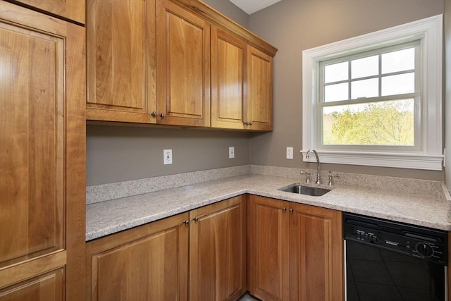 kitchen with black dishwasher, brown cabinets, and a sink