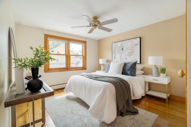 51 Burget Ave, Medford, MA 02155 - bedroom featuring baseboard heating, wood finished floors, and ceiling fan