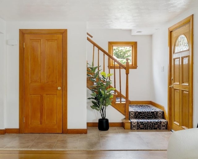 51 Burget Ave, Medford, MA 02155 - tiled foyer entrance with stairs and baseboards