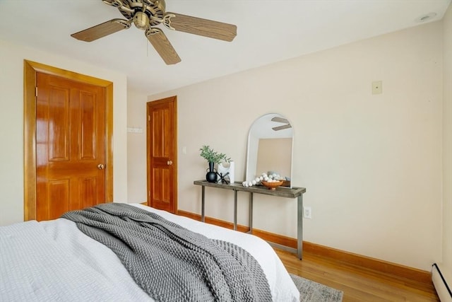 51 Burget Ave, Medford, MA 02155 - bedroom featuring wood finished floors, baseboard heating, baseboards, and ceiling fan