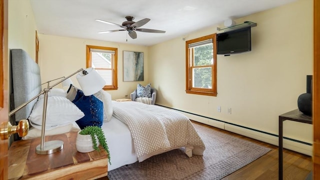 51 Burget Ave, Medford, MA 02155 - bedroom with multiple windows, wood finished floors, a baseboard heating unit, and a ceiling fan