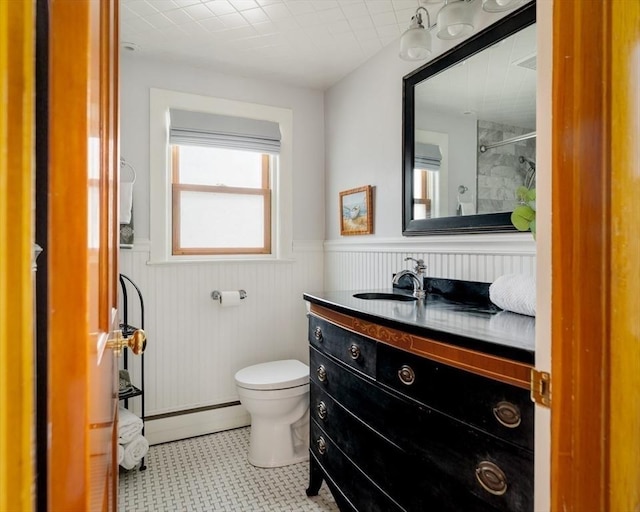 51 Burget Ave, Medford, MA 02155 - bathroom with a baseboard heating unit, wainscoting, toilet, vanity, and a shower