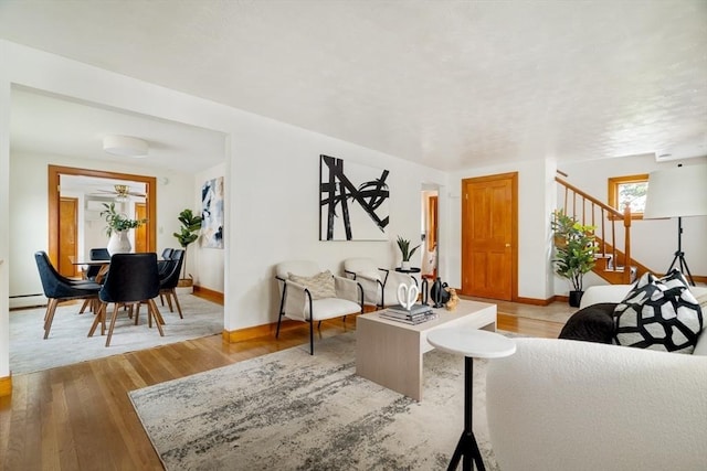 51 Burget Ave, Medford, MA 02155 - living room featuring baseboards, stairs, wood finished floors, and ceiling fan