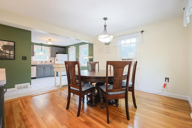 57 Hawes St, Wrentham, MA 02093 - dining area with light wood-style flooring and baseboards