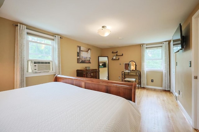 57 Hawes St, Wrentham, MA 02093 - bedroom featuring light wood finished floors, multiple windows, and cooling unit