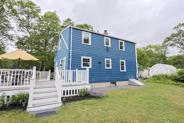 57 Hawes St, Wrentham, MA 02093 - back of house featuring a chimney, a yard, and a wooden deck