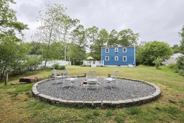 57 Hawes St, Wrentham, MA 02093 - view of green lawn featuring a deck and an outdoor fire pit