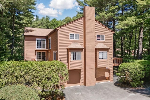 87 E Bluff Rd Unit 87, Ashland, MA 01721 - view of front of property with a garage, a chimney, and driveway