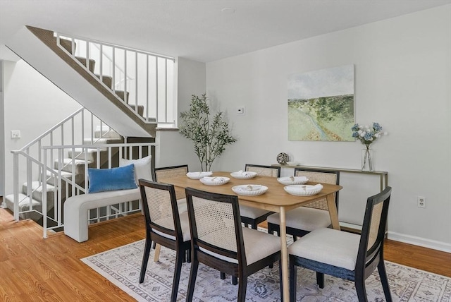 87 E Bluff Rd Unit 87, Ashland, MA 01721 - dining space featuring stairs, wood finished floors, and baseboards