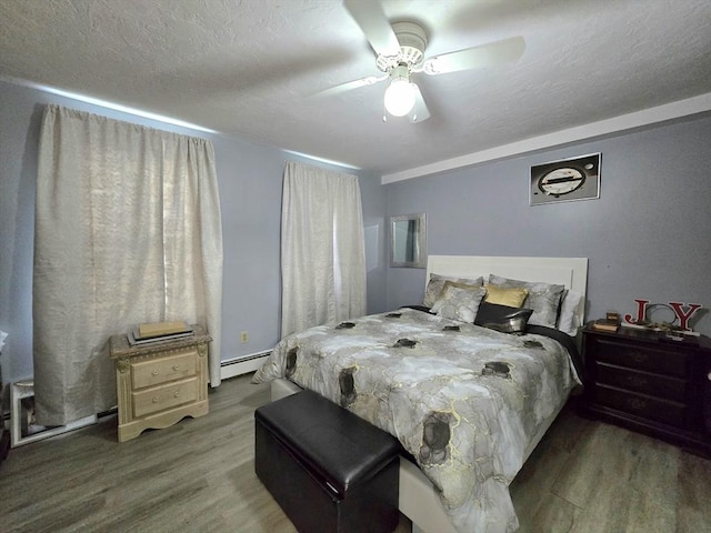 3 Main St, Spencer, MA 01562 - bedroom with wood finished floors, a baseboard heating unit, and a ceiling fan