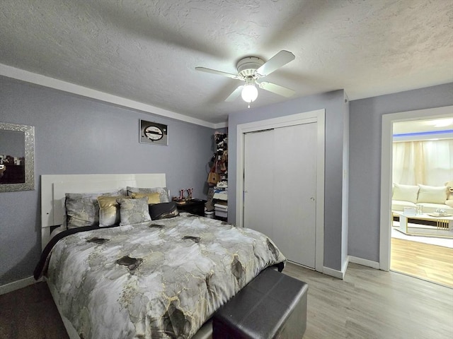 3 Main St, Spencer, MA 01562 - bedroom featuring light wood-type flooring, baseboards, a textured ceiling, a closet, and a ceiling fan