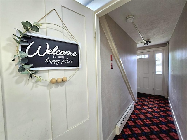 3 Main St, Spencer, MA 01562 - hallway featuring a baseboard radiator, baseboards, and carpet