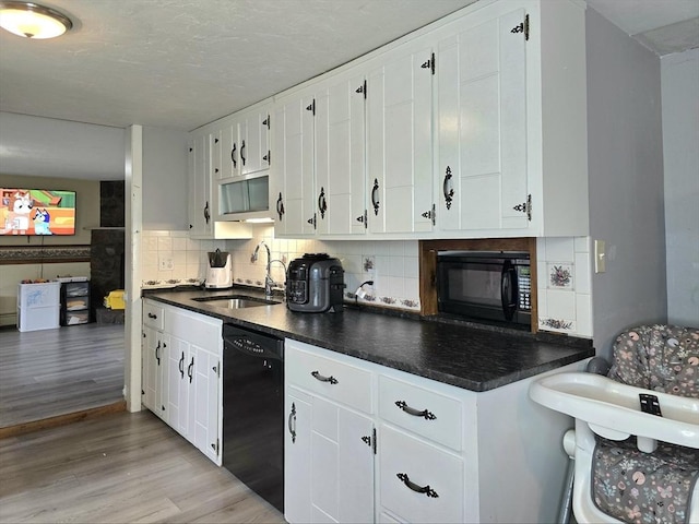 3 Main St, Spencer, MA 01562 - kitchen featuring black appliances, a sink, light wood-type flooring, dark countertops, and tasteful backsplash