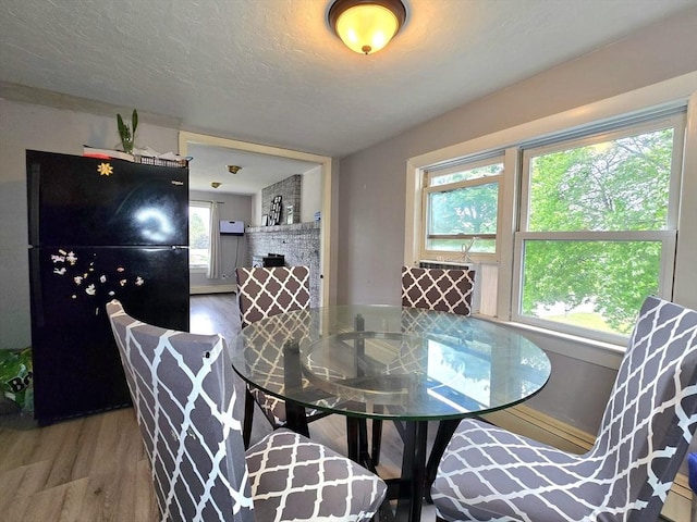 3 Main St, Spencer, MA 01562 - dining space featuring wood finished floors and a brick fireplace