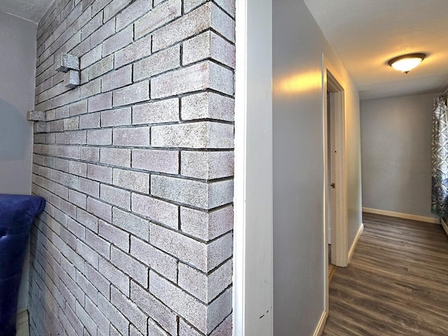 3 Main St, Spencer, MA 01562 - hall with baseboards, dark wood-type flooring, and brick wall