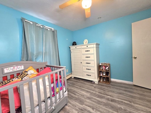 3 Main St, Spencer, MA 01562 - bedroom with wood finished floors, ceiling fan, baseboards, and a crib