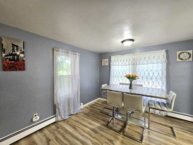 3 Main St, Spencer, MA 01562 - dining space with baseboard heating, healthy amount of natural light, wood finished floors, and baseboards