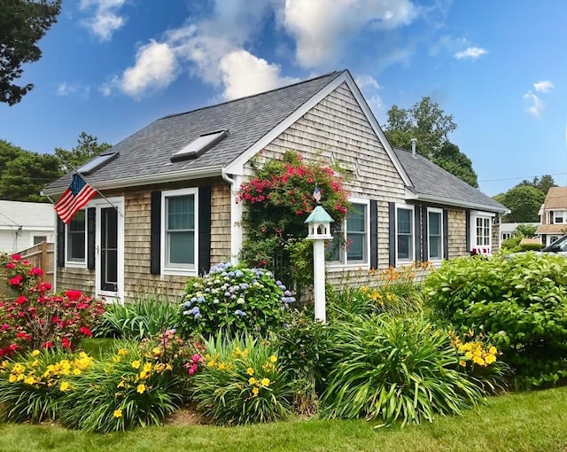 24 Park St, Bourne, MA 02559 - view of side of home with a shingled roof