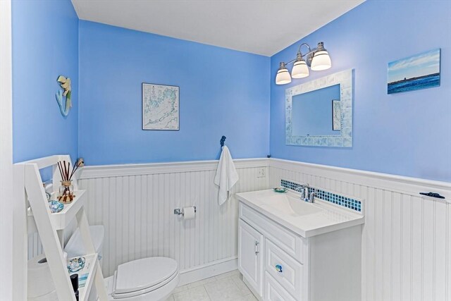 24 Park St, Bourne, MA 02559 - bathroom featuring toilet, wainscoting, and vanity