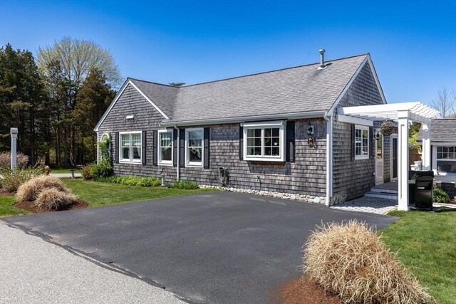 24 Park St, Bourne, MA 02559 - view of front of home with aphalt driveway, a front lawn, and roof with shingles