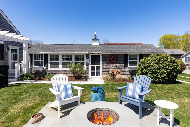 24 Park St, Bourne, MA 02559 - back of property featuring a lawn, a patio, and a fire pit