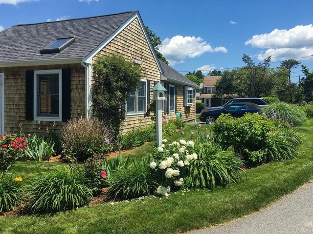 24 Park St, Bourne, MA 02559 - view of side of home featuring a shingled roof