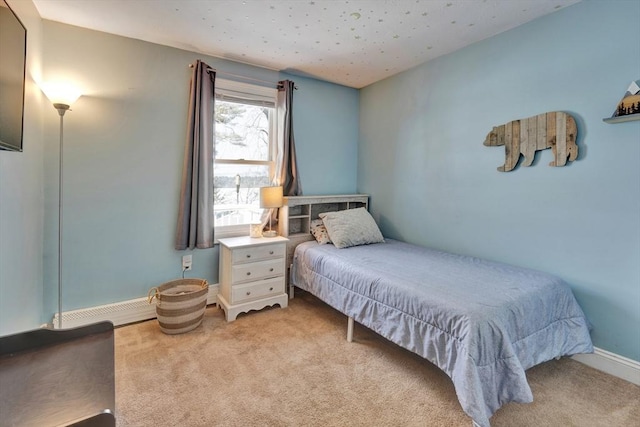 carpeted bedroom featuring baseboard heating