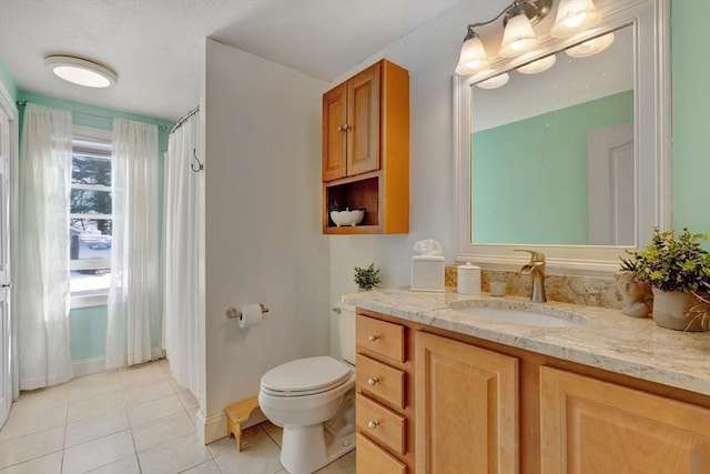 bathroom featuring vanity, toilet, and tile patterned flooring