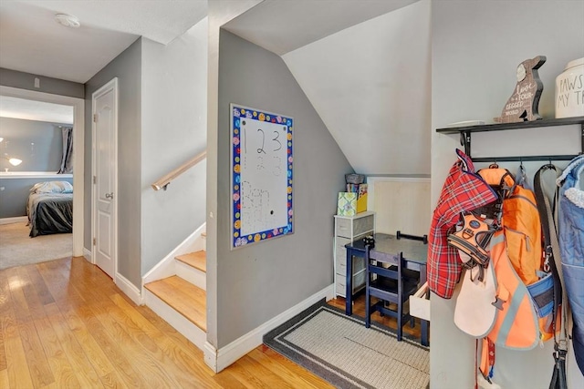 walk in closet featuring lofted ceiling and light hardwood / wood-style floors